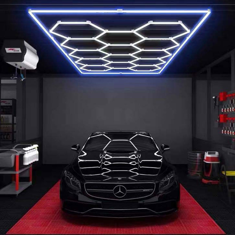 A black car in a garage with 14 Grid LED Hex System - Blue lights.