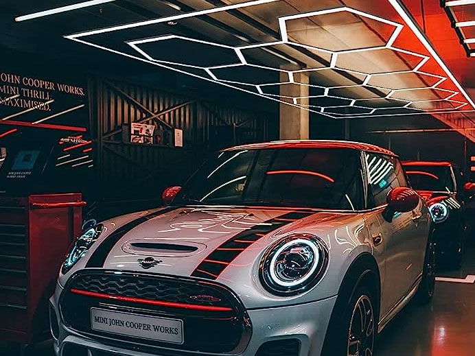 A mini cooper parked in a garage, illuminated by Canada Hex Lights.