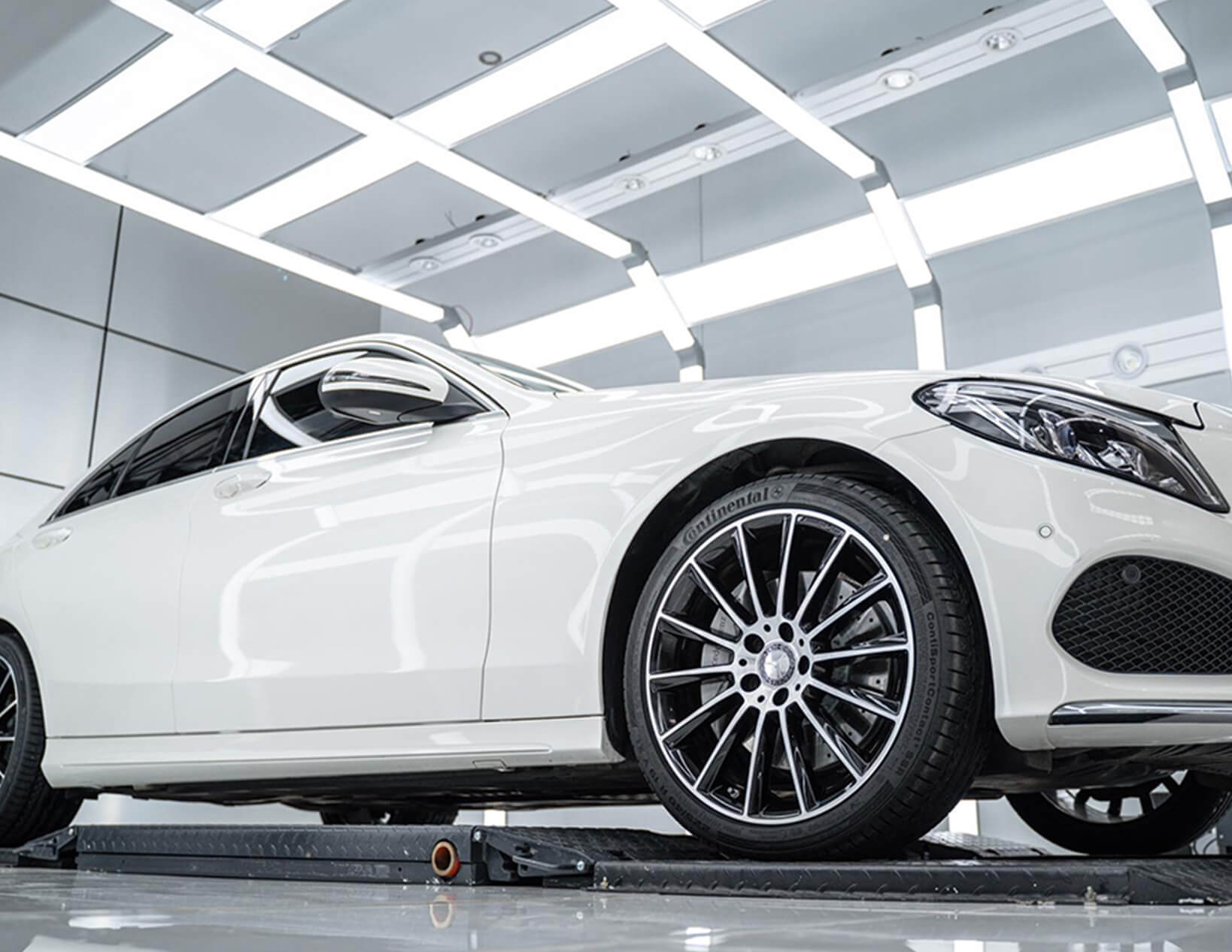 Mercedes-Benz E-Class showcased under custom Hex Lighting in a showroom.