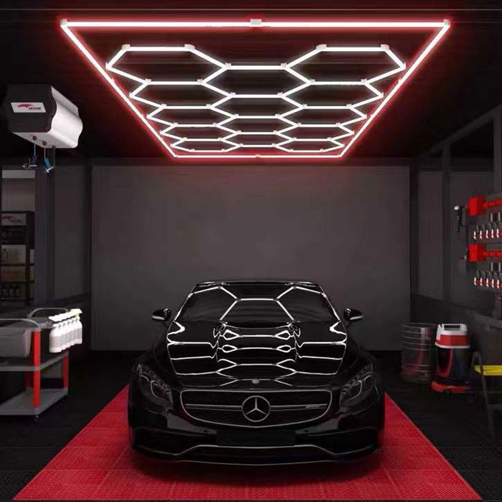 A black Mercedes Benz in a garage with a custom 14 Grid LED Hex System - Red lighting.